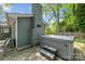 Backyard hot tub with steps, next to a gray brick house with a tall brick chimney, sitting on a gray brick patio at 2933 Hilliard Dr, Charlotte, NC 28205