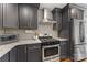 The kitchen boasts gray cabinets, granite countertops, and stainless steel appliances at 2933 Hilliard Dr, Charlotte, NC 28205