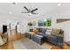 The living room features a ceiling fan and a large window for natural light at 2933 Hilliard Dr, Charlotte, NC 28205