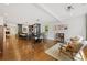 Open-concept living space featuring hardwood floors, modern furniture, and a view into the adjacent kitchen at 2933 Hilliard Dr, Charlotte, NC 28205