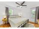 The main bedroom offers natural light with a ceiling fan and neutral colored decor at 2933 Hilliard Dr, Charlotte, NC 28205