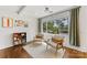 Cozy sitting area with comfortable chairs, a bookshelf, and a large window with natural light at 2933 Hilliard Dr, Charlotte, NC 28205