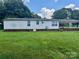 Backyard featuring a large lawn and the home's back exterior with a covered porch at 321 Jennings Rd, Statesville, NC 28625