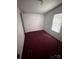 Small bedroom featuring red carpeting and natural light at 321 Jennings Rd, Statesville, NC 28625