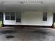View of car port featuring concrete flooring, fluorescent lighting, and access door at 321 Jennings Rd, Statesville, NC 28625