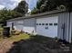 Exterior view of garage featuring multiple bays with roll-up doors at 321 Jennings Rd, Statesville, NC 28625