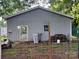 Rear view of garage featuring access door, window, and garbage cans at 321 Jennings Rd, Statesville, NC 28625