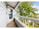 Condo balcony with wood floor, white railings, lake view, and door number 372 at 372 Northwest Dr, Davidson, NC 28036