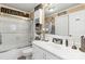 Well-lit bathroom featuring a shower over tub, vanity with storage, and mirrors for grooming at 372 Northwest Dr, Davidson, NC 28036