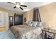 Cozy bedroom featuring a ceiling fan, patterned bedding, and a decorative canopy above the headboard at 372 Northwest Dr, Davidson, NC 28036