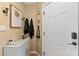 Inviting entryway with decorative artwork, hooks for coats, and a stylish storage cabinet at 372 Northwest Dr, Davidson, NC 28036