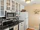 Modern kitchen with stainless steel appliances, glass-front cabinets, and sleek countertops, perfect for cooking at 372 Northwest Dr, Davidson, NC 28036