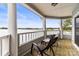 Covered porch featuring lovely lake views and comfy outdoor seating at 372 Northwest Dr, Davidson, NC 28036