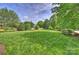 Large backyard shows expansive lawn, landscaping and mature trees at 4122 Banfield Pl, Charlotte, NC 28226