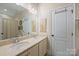 Bathroom featuring double sinks, tile flooring, and custom mirror at 4122 Banfield Pl, Charlotte, NC 28226