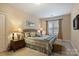 Bedroom with comfortable furnishings, neutral tones, and a window with curtains at 4122 Banfield Pl, Charlotte, NC 28226