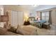 Bedroom with comfortable furnishings, neutral tones, and a window with curtains at 4122 Banfield Pl, Charlotte, NC 28226