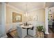 Elegant dining area featuring marble table, chandelier, and decorative columns at 4122 Banfield Pl, Charlotte, NC 28226