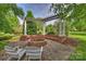 Outdoor brick firepit with seating and pergola overhead for entertaining at 4122 Banfield Pl, Charlotte, NC 28226
