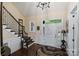 Elegant home foyer featuring hardwood floors, staircase with a white front door at 4122 Banfield Pl, Charlotte, NC 28226