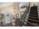 Grand foyer with dark hardwood floors, staircase with carpet runner, and chandelier at 4122 Banfield Pl, Charlotte, NC 28226