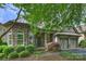 Stunning stone home featuring an arched entryway, manicured landscaping, and attached two car garage at 4122 Banfield Pl, Charlotte, NC 28226