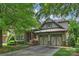 Charming home with a two-car garage, stone accents, mature trees and landscaping at 4122 Banfield Pl, Charlotte, NC 28226
