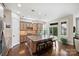 Well-equipped kitchen with an island, wooden cabinets, and a breakfast bar with stools next to large window at 4122 Banfield Pl, Charlotte, NC 28226