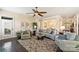Bright living room with a ceiling fan, hardwood floors, and lots of furniture and decor at 4122 Banfield Pl, Charlotte, NC 28226