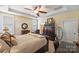 Comfortable primary bedroom suite features a tray ceiling, fan and traditional furnishings at 4122 Banfield Pl, Charlotte, NC 28226