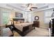 Elegant primary bedroom suite featuring a trey ceiling, fan and luxurious furnishings at 4122 Banfield Pl, Charlotte, NC 28226