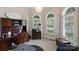 Bright office space with wooden desk, arched windows, and plantation shutters at 4122 Banfield Pl, Charlotte, NC 28226