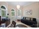 Bright office space with arched windows, plantation shutters, and a modern chandelier at 4122 Banfield Pl, Charlotte, NC 28226