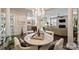 Open-concept with kitchen and fireplace viewed from elegant dining area with marble table at 4122 Banfield Pl, Charlotte, NC 28226