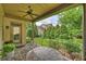 Covered patio with brick flooring, fan, and table with chairs overlooking the yard at 4122 Banfield Pl, Charlotte, NC 28226