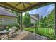 Covered patio view shows fan, table and chairs, and manicured backyard at 4122 Banfield Pl, Charlotte, NC 28226