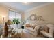 Cozy sitting room with comfortable seating, natural light, and decorative clock at 4122 Banfield Pl, Charlotte, NC 28226