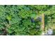 Aerial view of property nestled within lush, dense green forest, providing privacy and natural beauty at 4705 Campground View Rd, Catawba, NC 28609