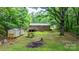 Expansive backyard with mature trees, a shed, and an outdoor fire pit at 4705 Campground View Rd, Catawba, NC 28609