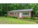 Charming brick home with metal roof, manicured landscaping, and decorative window accents at 4705 Campground View Rd, Catawba, NC 28609
