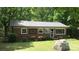 Charming brick home featuring a metal roof, well-manicured lawn, and surrounded by lush greenery at 4705 Campground View Rd, Catawba, NC 28609