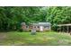 Charming brick house surrounded by green trees, featuring a lawn and a stone ornament at 4705 Campground View Rd, Catawba, NC 28609