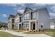 Charming townhomes with varied siding, brick accents, and well-maintained lawns showcase modern living at 5201 Shasta St # 5201, Gastonia, NC 28052
