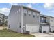 Side view of a gray two-story home with an attached two car garage and a well maintained lawn at 5201 Shasta St # 5201, Gastonia, NC 28052