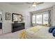 Beautiful bedroom with a large dresser, mirror, ceiling fan, and natural light from the windows at 5201 Shasta St # 5201, Gastonia, NC 28052
