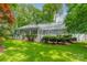 Back of the house with large picture windows, a deck area and a lush green backyard with mature landscaping at 532 Courtney Ln, Matthews, NC 28105