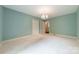 Spacious bedroom with carpet, pale blue walls, and a chandelier at 532 Courtney Ln, Matthews, NC 28105