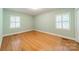 Bedroom with hardwood floors and natural light from two windows at 532 Courtney Ln, Matthews, NC 28105