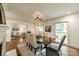 View of the dining room, showcasing fireplace, hardwood floors, and view to the living room at 532 Courtney Ln, Matthews, NC 28105