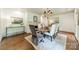Dining room with hardwood floors, area rug, dining table and chandelier at 532 Courtney Ln, Matthews, NC 28105